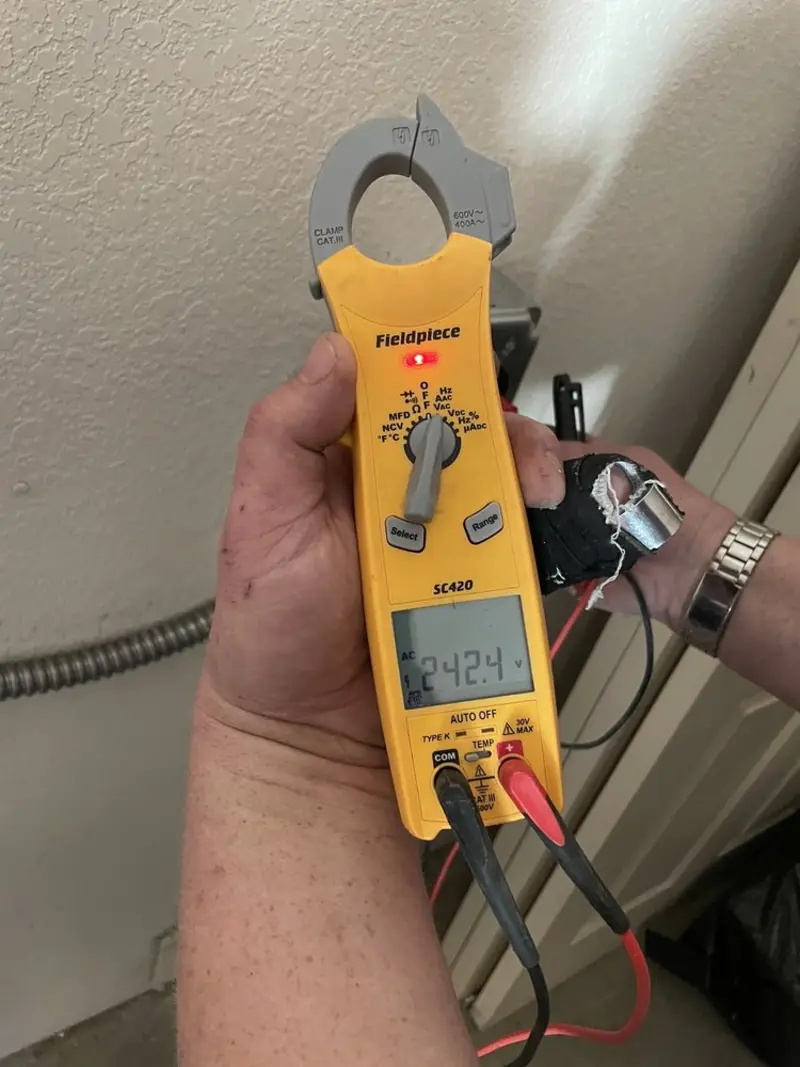 Voltage testing with clamp meter during Ceiling Fan Installation in Crookston